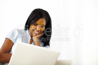 Relaxed young woman working on laptop