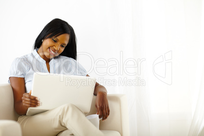 Calm young woman working on laptop