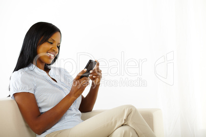 Happy young woman using a mobile phone