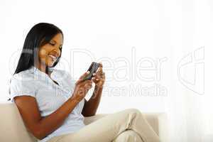 Happy young woman using a mobile phone