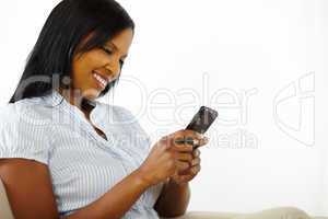 Charming young woman using a mobile phone