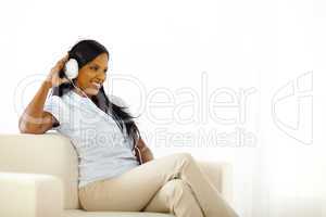 Happy young lady listening to music