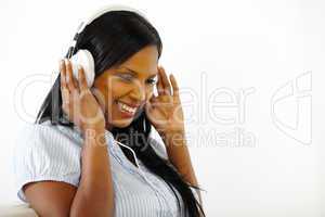 Happy young female listening to music