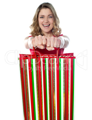 Excited teenager holding shopping bags