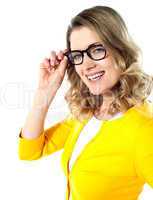 Smiling caucasian woman wearing and holding her glasses