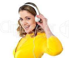 Beautiful young woman with headphones listening music