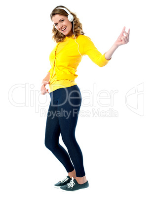 Rock style woman with headphones listening to music