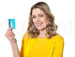 Portrait of young smiling woman holding credit card