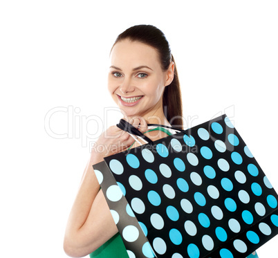 Close-up of happy shopping girl holding bags