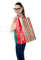 Side view of woman holding shopping bags