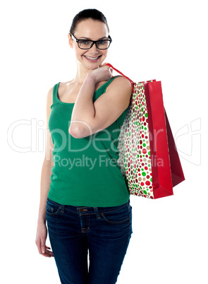 Smiling young female carrying shopping bags