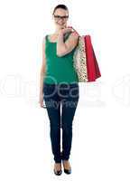 Full length view beautiful woman holding shopping bags