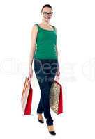 American beauty holding shopping bags, walking pose