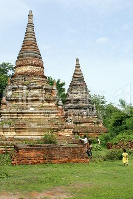 Brick stupas and green grass