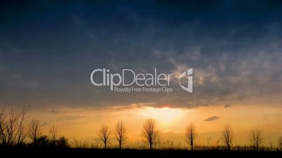 time lapse clouds and silhouettes of trees.