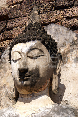 Buddha's head and wall