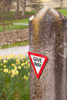 Give way sign on old stone gatepost