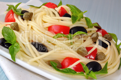 Spaghetti with tomato, capers and basil with olives