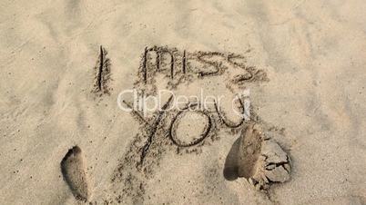 I miss you written in the sand