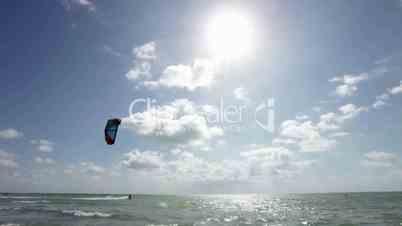 Young man kitesurfing