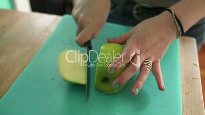 Teenage girl slicing apple