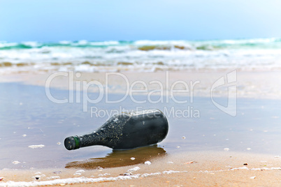 bottle with a note on the sea shore