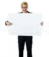 Saleswoman pointing at blank billboard