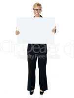 Smiling young lady holding blank banner ad
