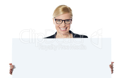 Portrait of happy woman showing blank placard