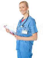 Experienced female doctor with clipboard