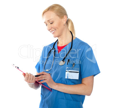 Senior female doctor writing report