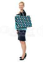 Beautiful woman standing with shopping bag