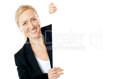 Smiling aged female executive holding clipboard