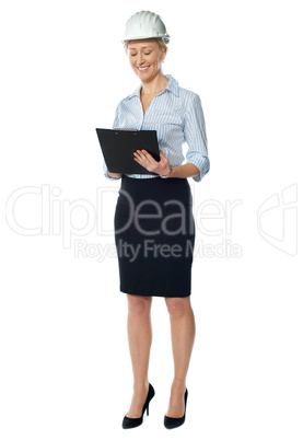 Elderly female architect studying file