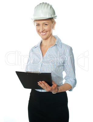 Smiling female architect holding documents