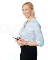 Beautiful corporate female using cellphone