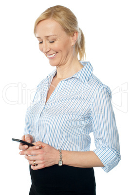 Smiling young corporate lady messaging