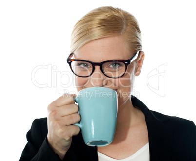 Attractive corporate female drinking coffee