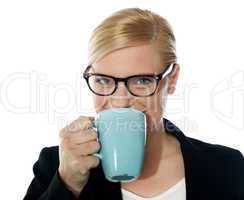 Attractive corporate female drinking coffee