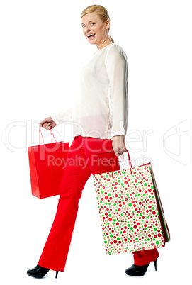 Pretty woman with shopping bags, walking