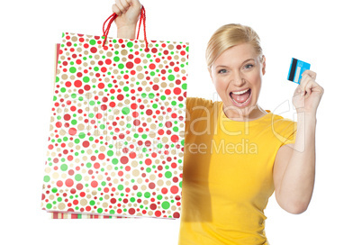 Beautiful girl posing with shopping paper bag