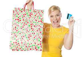 Beautiful girl posing with shopping paper bag