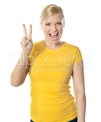 Young and beautiful teenage girl doing victory sign