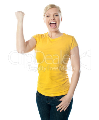 Fashionable teenager poisng with raised arms