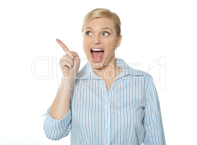 Excited female business executive pointing away