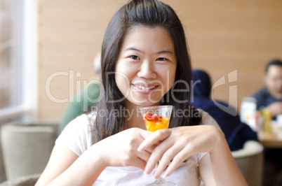 Asian woman enjoying her dessert