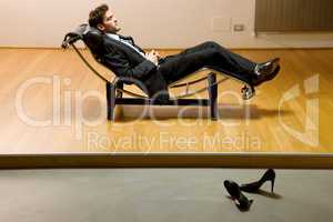 man lying on chaise longue