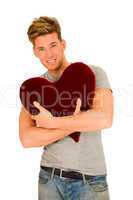 young man embracing a heart shaped pillow