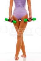legs of a young caucasian woman in lingerie back with dumbbells