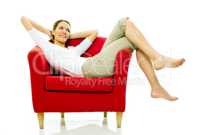 Young woman sitting on a chair on white background studio